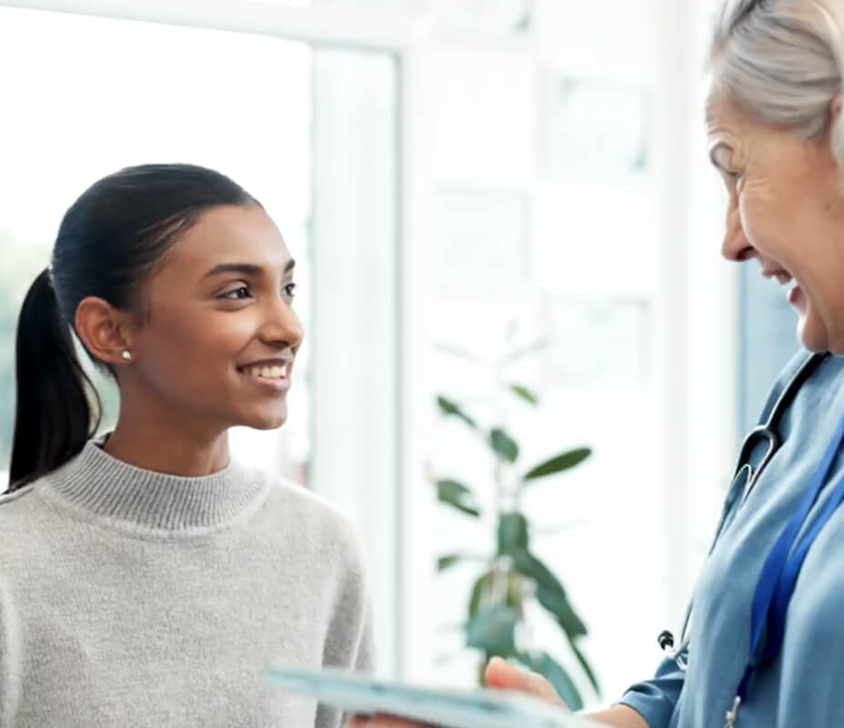 female physician focusing on patient during encounters while generating clinical notes