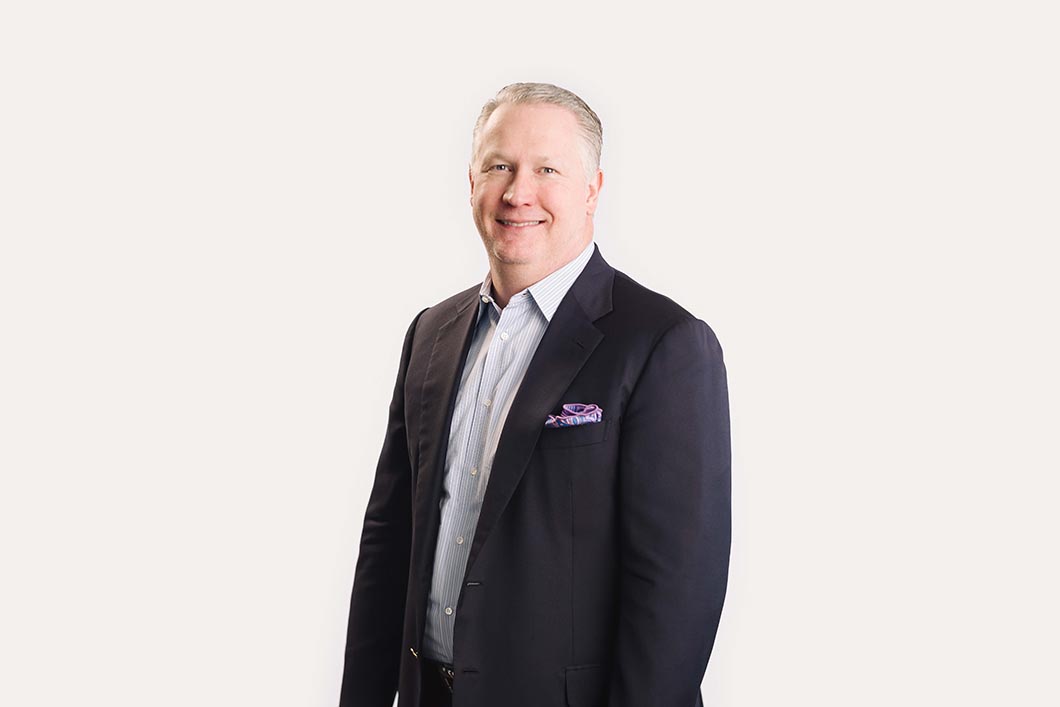 A smiling man in a suit posing for a picture