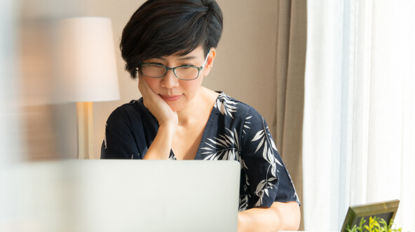 Female patient accessing her medical records on laptop at home