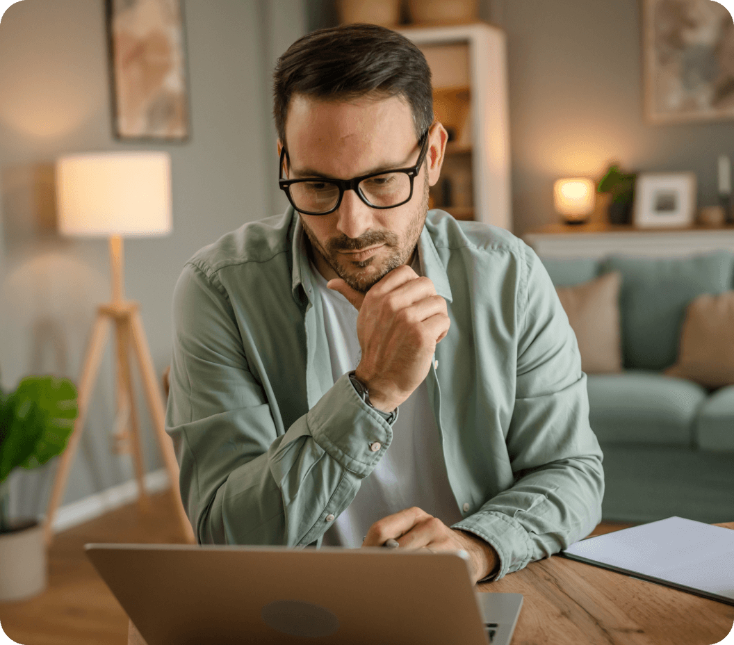 A male viewing his medical practice's patient portal on laptop in home setting